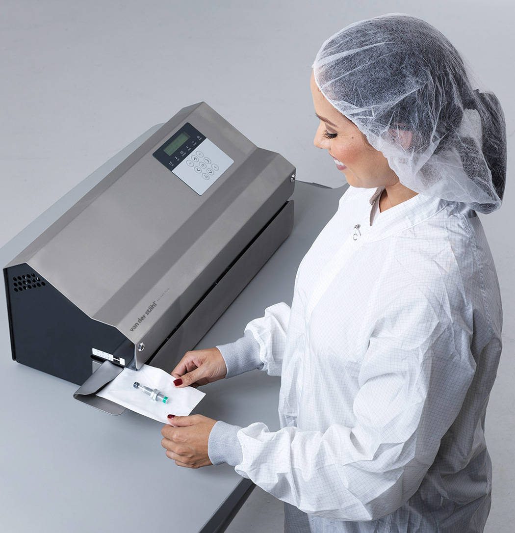 Woman using the MD 880 medical packaging machine